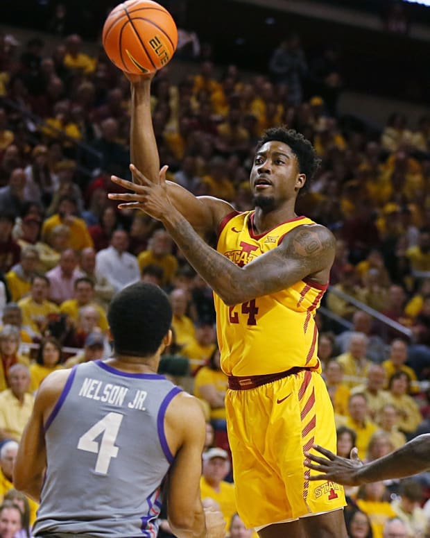 Iowa State Cyclones forward Hason Ward (24) passes the ball between TCU Horned Frogs guard Jameer Nelson Jr. (4) and forward Emanuel Miller (2) during the first half in the Big-12 conference showdown of a NCAA college basketball at Hilton Coliseum on Saturday, Feb. 10, 2024, in Ames, Iowa.